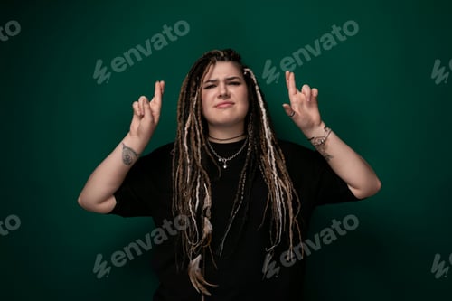 Preview: Woman With Dreadlocks Standing in Front of Green Background