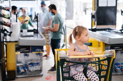 Preview: Tired kid girl in shopping cart