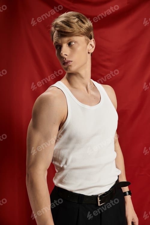 Preview: Young man showcasing modern masculinity with confidence and allure against a bold backdrop
