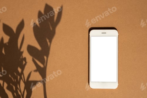 Preview: Smartphone on brown pastel colored background. Mobile phone Mock up