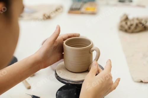 Preview: Crafting a clay mug at a pottery studio during a creative workshop