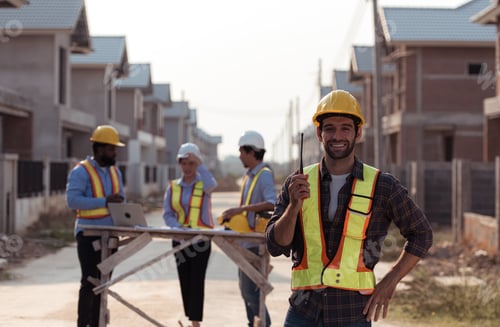 Preview: Portrait of engineers work together to assess the residential home construction site's progress