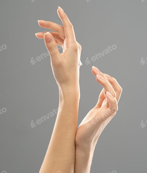 Preview: Woman applies a cosmetic moisturizer on her hands.