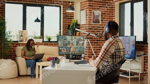 Preview: Company employee attending online videocall meeting at home