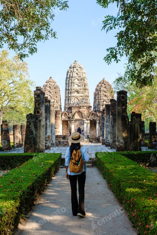 Preview: Asian women visiting Wat Si Sawai, Sukhothai old city, Thailand. Sukothai historical park
