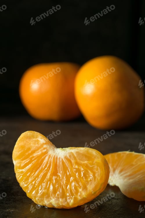 Preview: A close up of a juicy segment of an orange tangerine