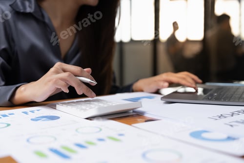 Preview: Business asian woman accountant or financial expert analyze business report graph and finance chart