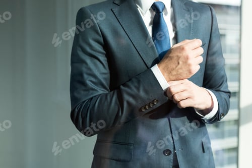 Preview: Businessman adjusting cuffs