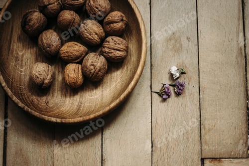 Preview: natural nuts and in a stylish unique rustic bowl on a wooden background