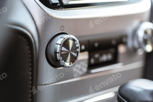 Preview: Control knob and display in modern car interior during daytime driving