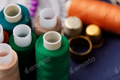 Preview: Threads and sewing accessories on brown wooden table