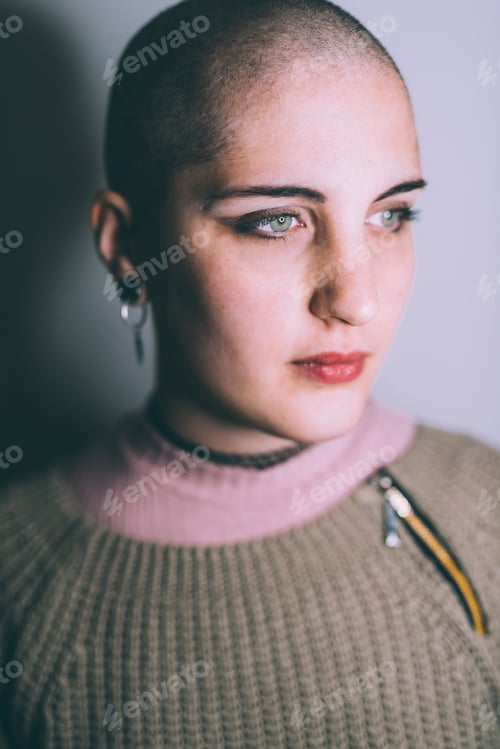 Preview: Head and shoulder portrait of blue eyed young woman with shaved head