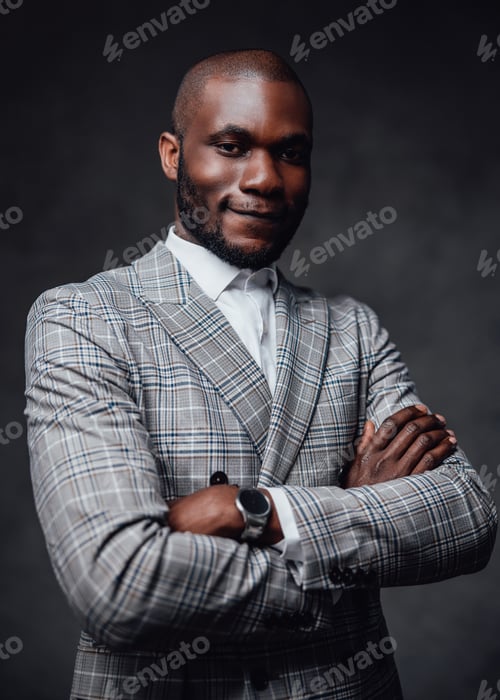 Preview: Well-dressed african business big shot looking at camera