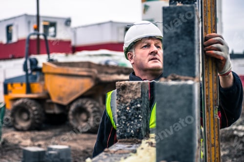 Preview: Workers laying bricks on construction site