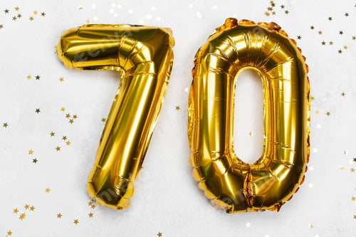 Preview: Celebrating a special milestone with golden balloons for a 70th birthday party