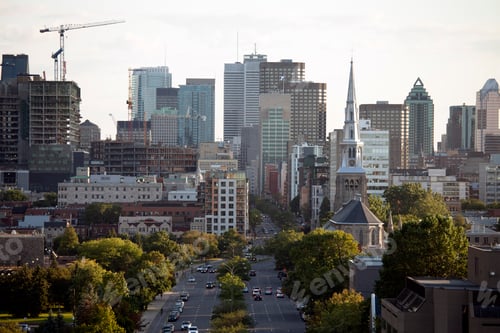 Preview: Elevated view of Quebec city, green space, tall buildings, major road and construction.