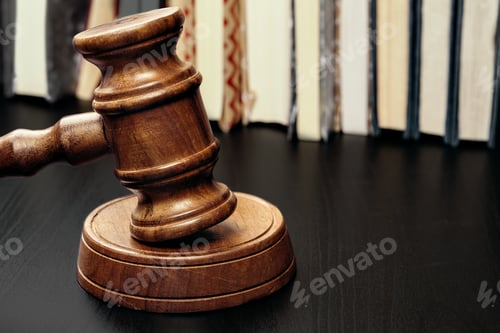 Preview: Judge's gavel on wooden table in dark