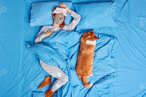 Preview: Home spa procedures. Pretty smiling woman wears pajama and soft sleeping mask enjoys domestic beauty