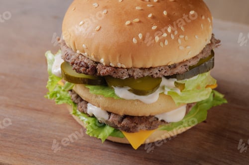 Preview: perfect tasty big double burger on wooden table on brown background
