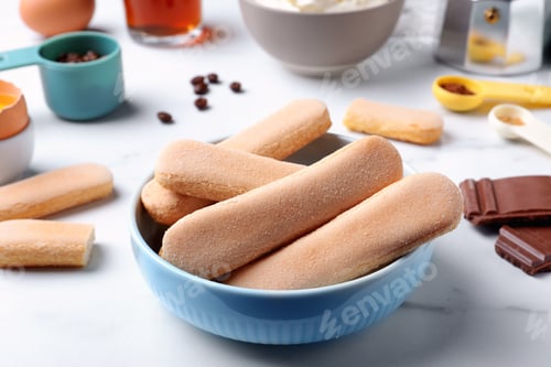 Preview: Tasty cookies and other ingredients for tiramisu on white table