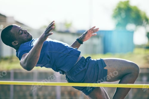 Preview: Man, high jump and fitness or athletics at a stadium for training, energy and cardio against sky ba