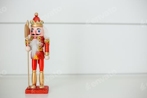 Preview: Red and gold glittery nutcracker on a white background