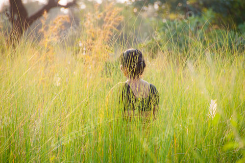 Preview: Beauty young woman outdoors green grass enjoying nature at sunset. blurred nature background