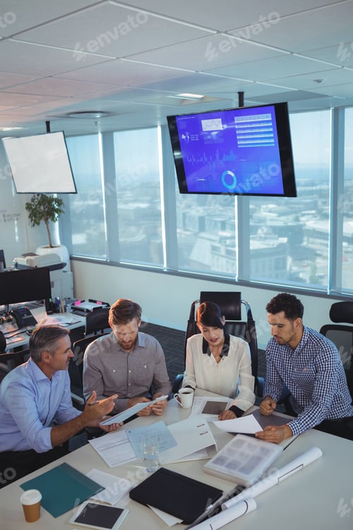 Preview: Business partners discussing in meeting at office desk