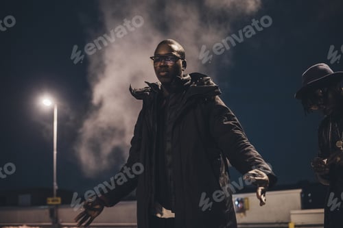 Preview: portrait of young african man standing in the street and looking camera