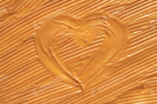 Preview: Smooth peanut butter with heart shape imprint reflecting love and care in food