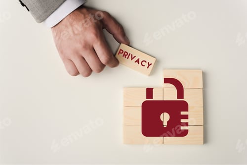 Preview: partial view of man holding brick with 'privacy' lettering over wooden blocks with lock icon