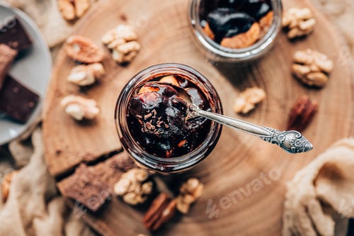 Preview: top view of sweet c chocolate dessert in glass jar with spoon