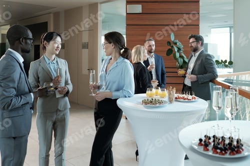 Preview: Young intercultural entrepreneurs with champagne discussing best reports