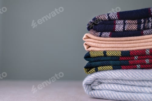 Preview: Stack of woolen checked blankets