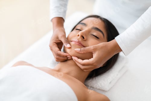 Preview: Beautiful Young Indian Woman Getting Face Lifting Massage In Spa