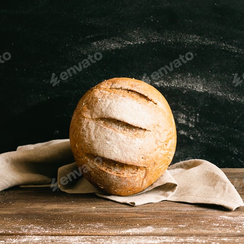 Preview: Fresh baked bread dark background. Minimalism food concept. Square frame copy space