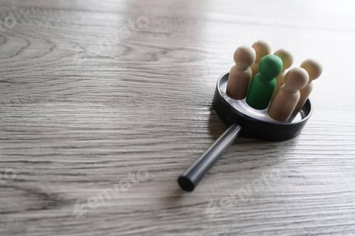 Preview: Wooden dolls on top of magnifying glass.
