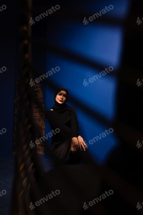 Preview: Stylish creative portrait of hijabi model in blue-toned studio
