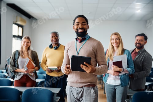 Preview: Happy black professor and his adult students in lecture hall looking at camera.