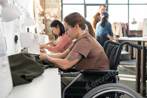 Preview: Two females sewing clothes in workshop