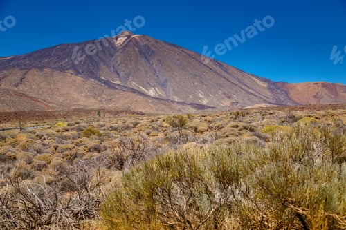 Preview: Captivating view of Mount Teide towering over a rugged volcanic landscape in Tenerife, Spain