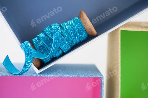 Preview: Wooden reel of sparkly blue ribbon in gift box