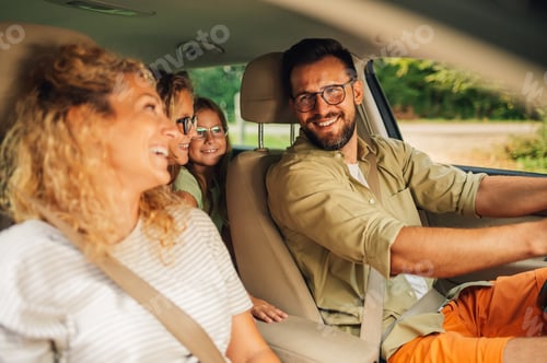 Preview: Portrait of a happy family traveling together in a car