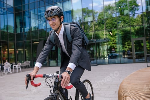 Preview: Young manager commuting to the office on a bike