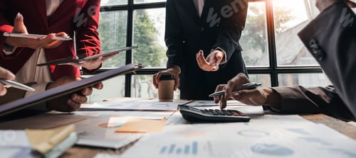 Preview: Business People Meeting using laptop computer,calculator,notebook,stock market chart paper for