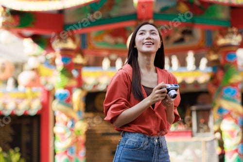 Preview: Young asian woman traveling, exploring temple, holding camera