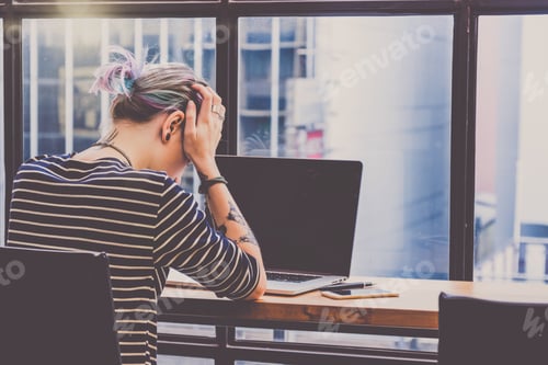 Preview: Back side of Depressed Hipster young Woman freelancer thinking about her job in serious action