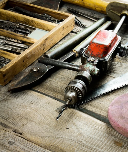 Preview: Drills in box, drill, chisel on a wooden background.