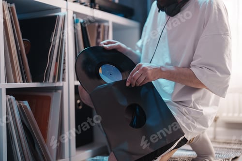 Preview: Music enthusiast browsing vinyl records at home