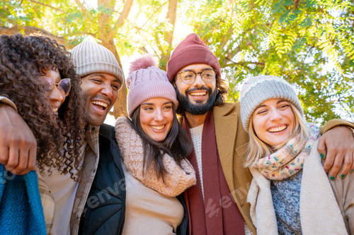 Preview: Friends smiling for a picture in a park enjoying the fun together.
